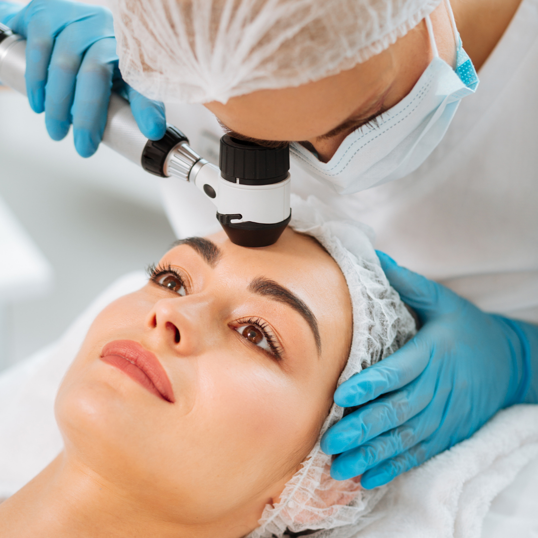 Dermatologist inspecting a woman's skin using dermatoscope Advanced Dermatology